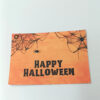 Ευχετήρια κάρτα πορτοκαλί Halloween με ιστούς αράχνης και μαύρο κείμενο “Happy Halloween”
